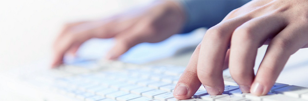 hands typing on computer keyboard